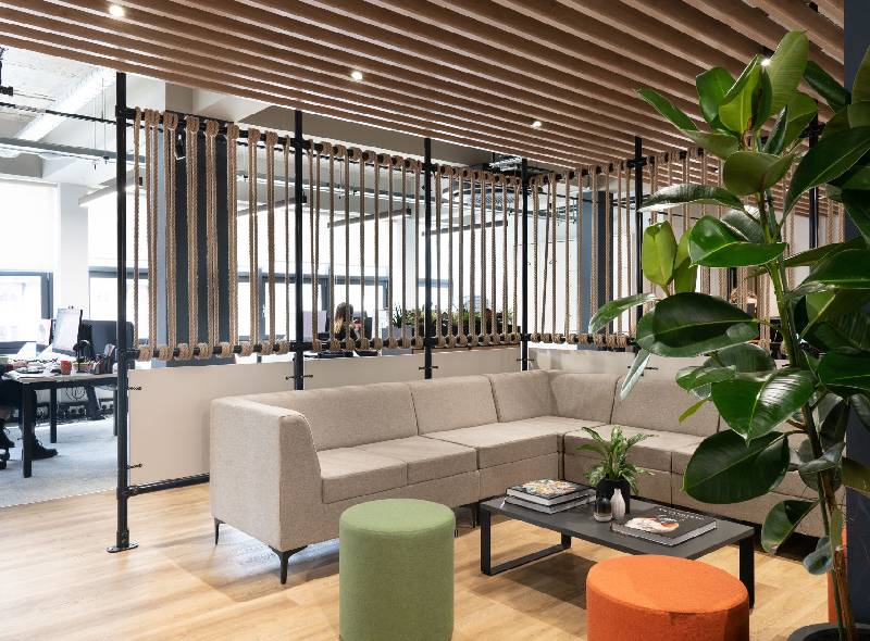 Contemporary breakout office space featuring premium office furniture, collaborative seating, and stylish commercial office interiors.